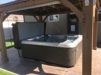Hot tub under wooden gazebo